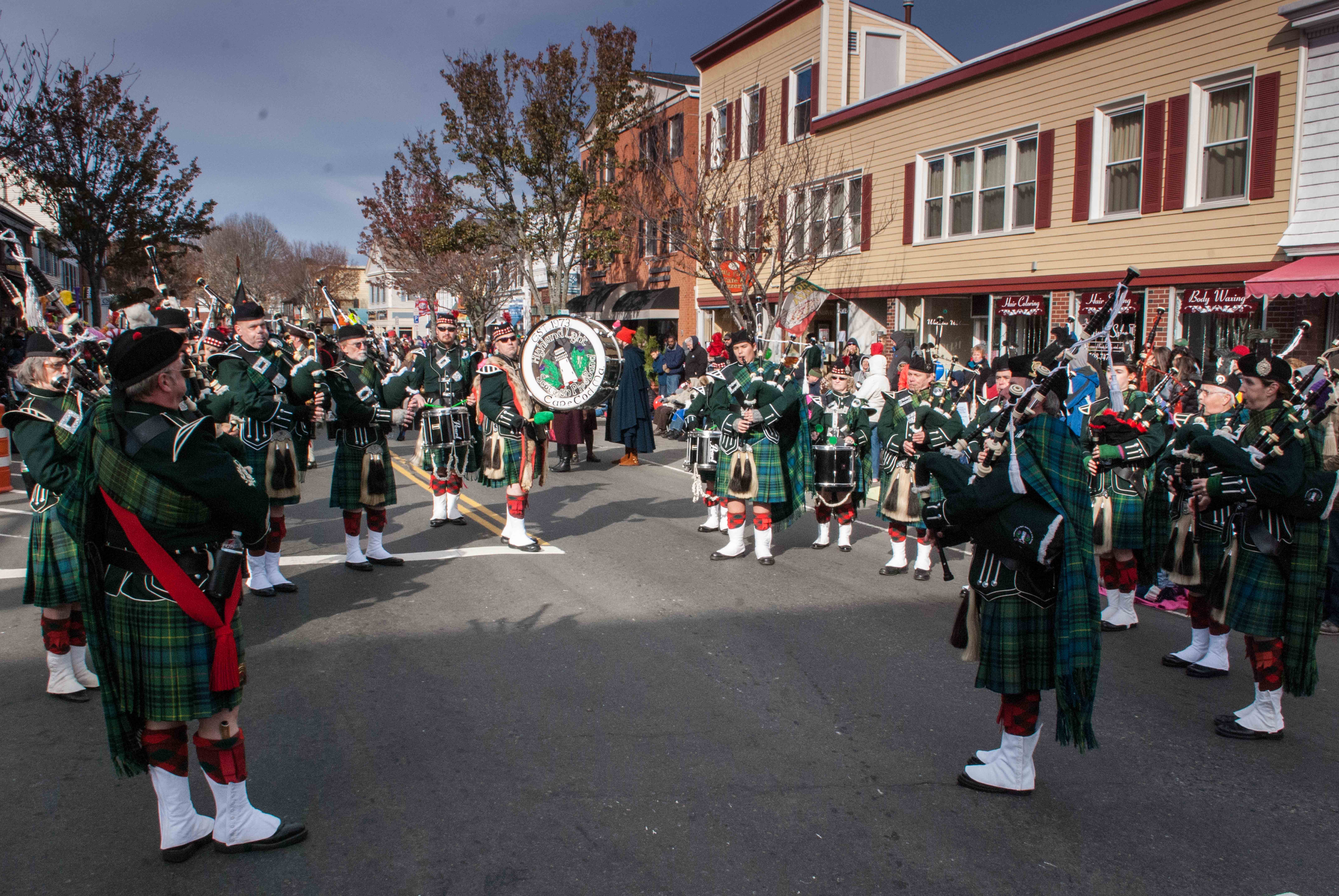 The Highland Light Pipe Band circled up to play a slow air during a parade.